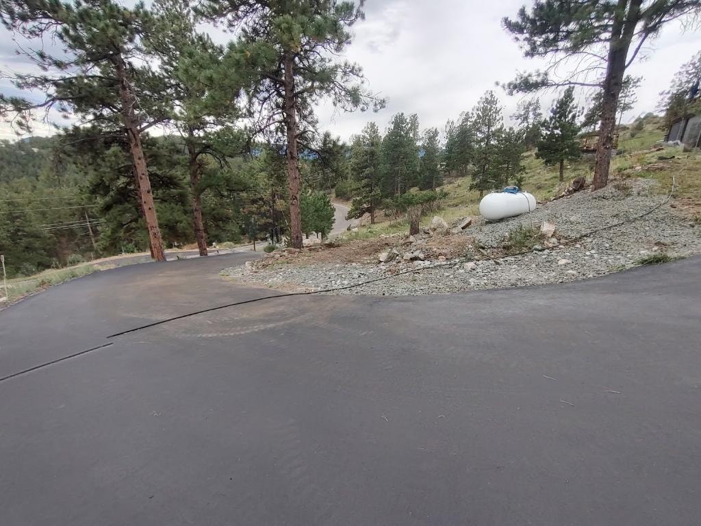 Stand-on tracked loader on mountain driveway